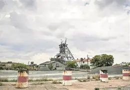 Heavy mining equipment operating in an open-cast mine illustrating the economic and operational challenges facing South Africa's mining industry.